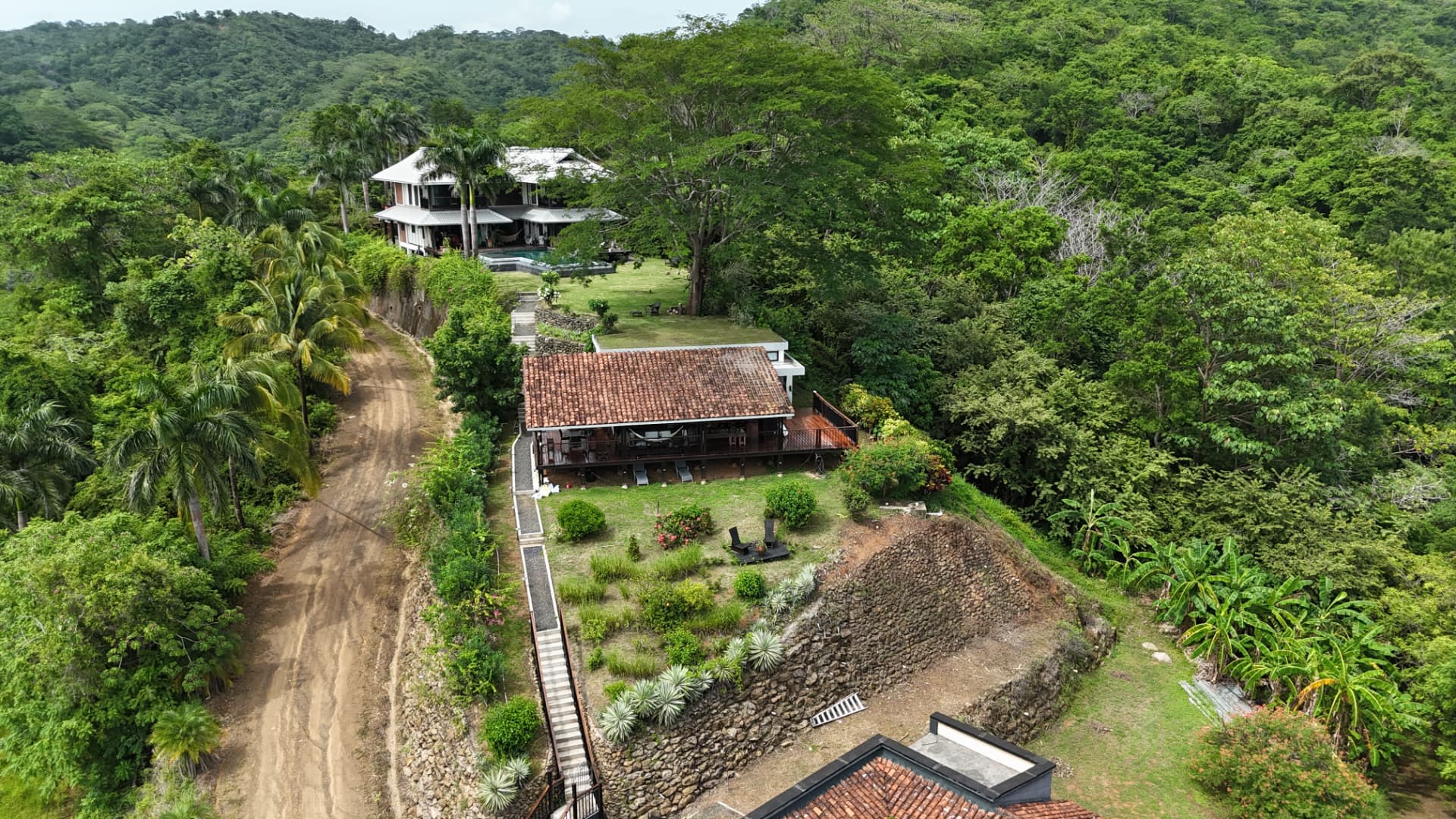 The casita with its red tiled roof half hidden among tall tropical trees