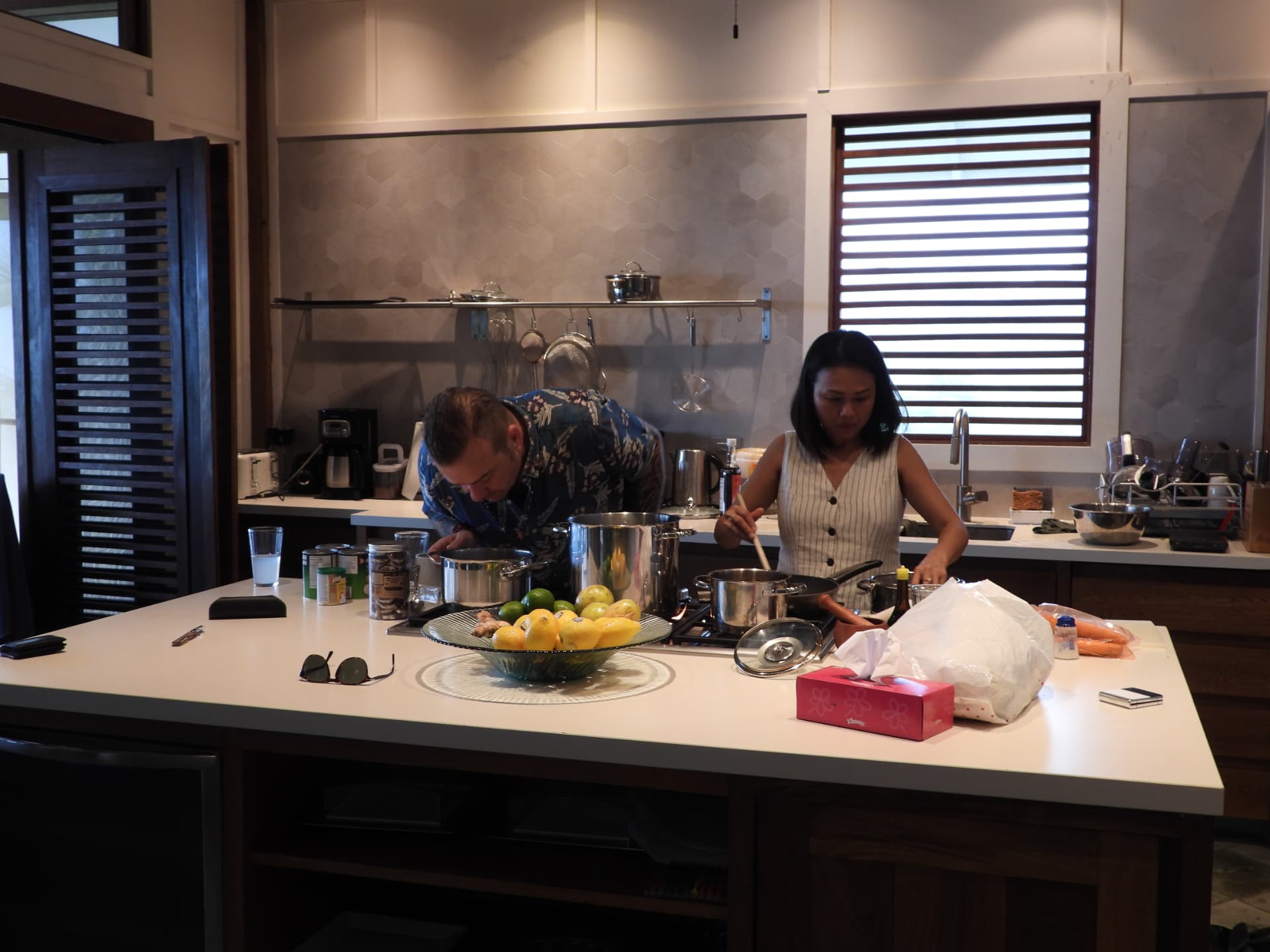 Two people cooking together in the open kitchen at Denter Tumas