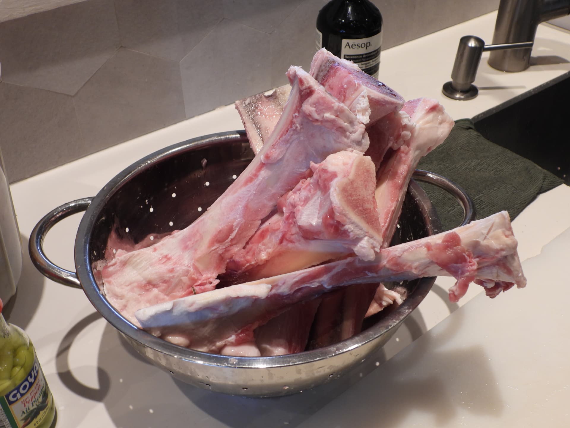 Fresh bones in a colander, ready for a slow stock in the kitchen at Denter Tumas